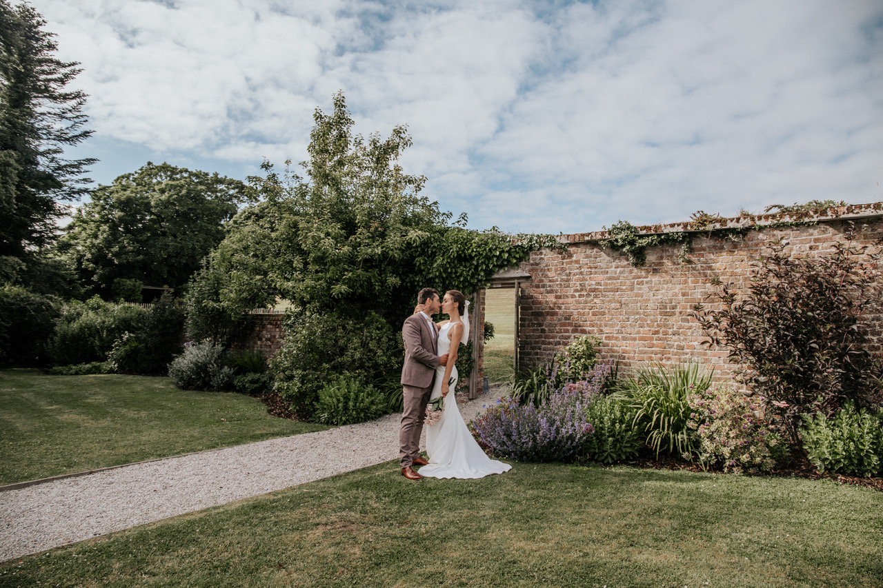 Newlyweds in the walled garden at Launcells Barton